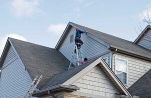 A home with a snow-covered roof and icicles, highlighting seasonal roofing challenges.